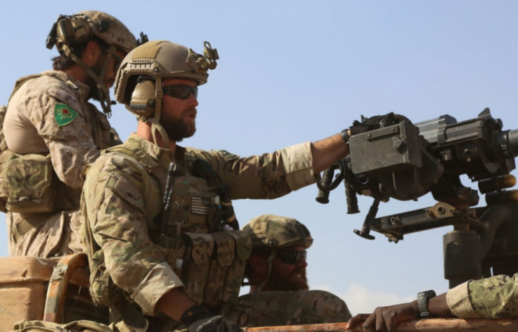 Three US Army Special Forces members manning an Mk 47 Striker