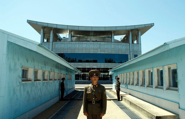 North Korean soldiers standing in front of the Military Demarcation Line between North and South Korea