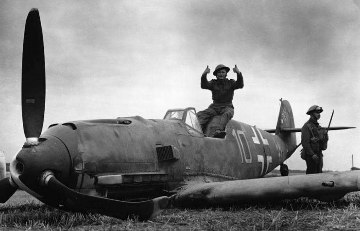 British airman sitting in the downed Messerschmitt Bf 109 'Yellow 10'