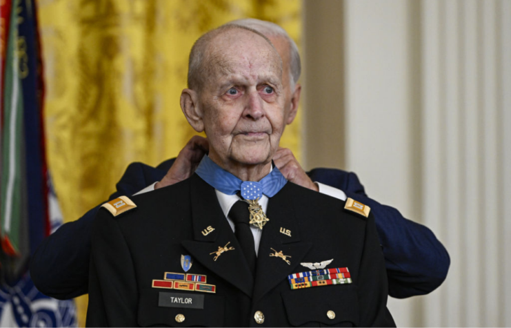 Joe Biden placing the Medal of Honor around Larry Taylor's neck