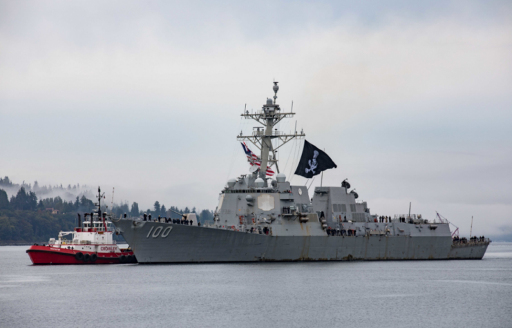 USS Kidd (DDG-100) transiting alongside a smaller vessel