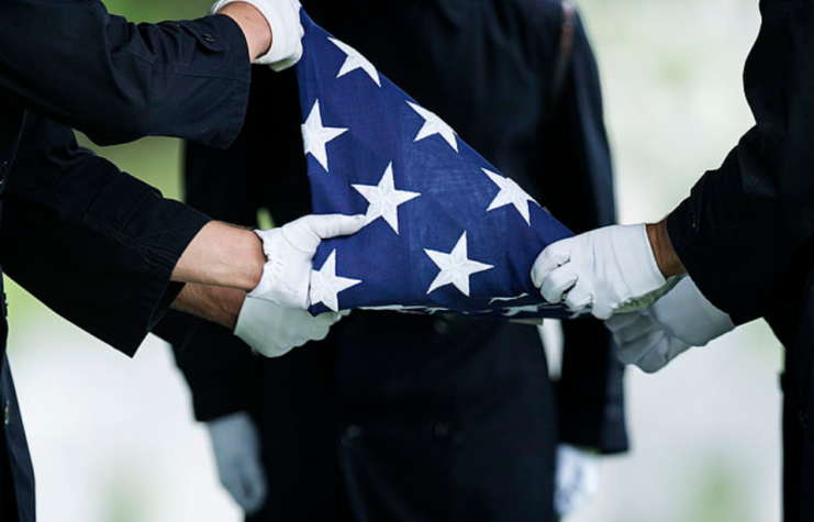 US Army soldiers folding the American flag into a triangle