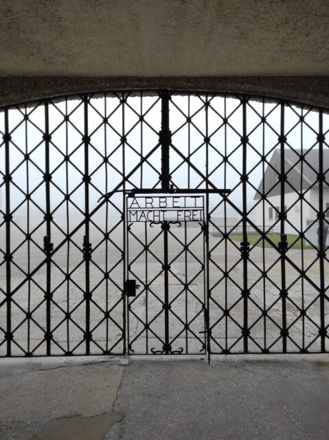 Gates of Dachau concentration camp, with "ARBEIT MACH FREI" written above the door. 