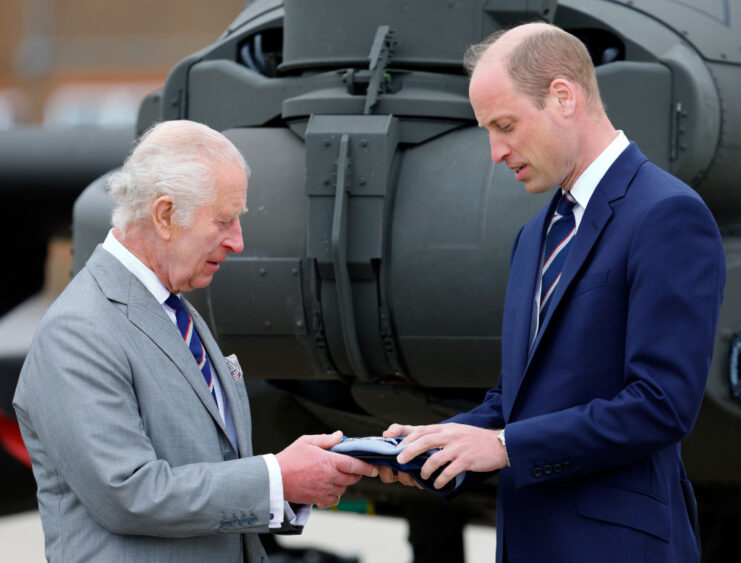 King Charles III handing William, Prince of Wales the beret of the Army Air Corps