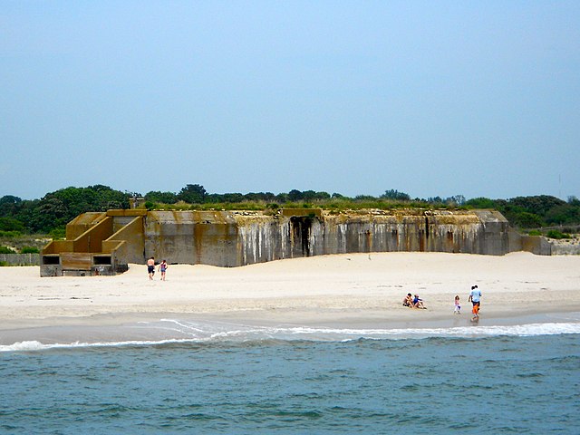 Beachgoers standing near Battery 223