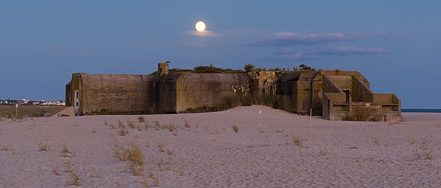 View of the moon rising over Battery 223 at dusk