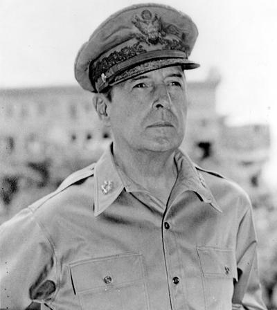 Black and white. man in military uniform and hat looking to the right. Head and shoulders. 