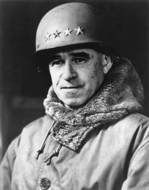 Black and white. Portrait of man in military uniform, fur scarf and helmet with four stars. 