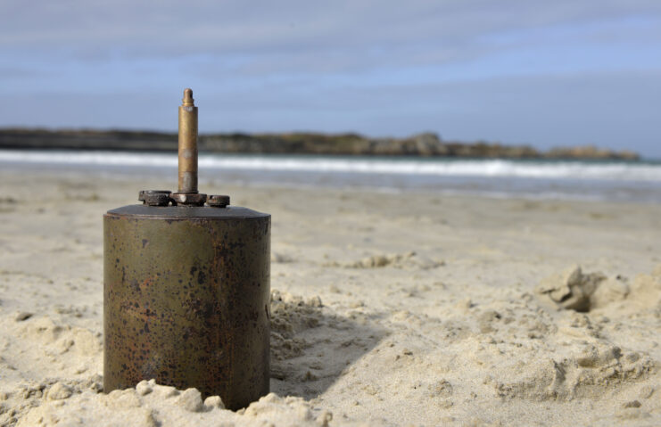S-Mine poking out of the sand at a beach on Guernsey