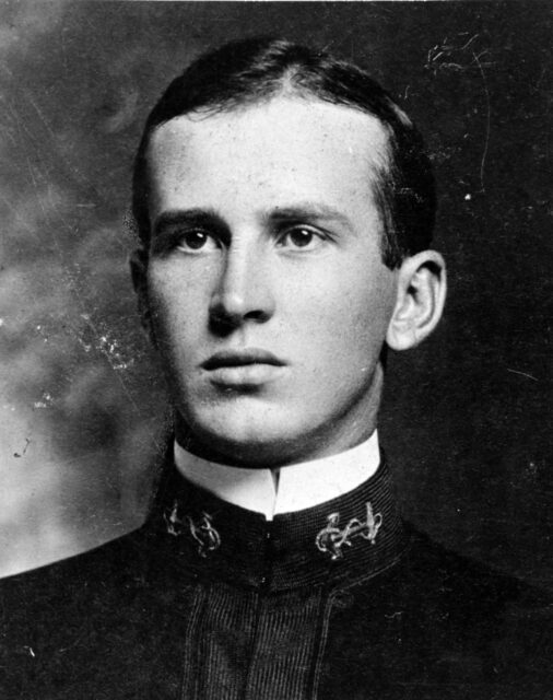 Black and white. Portrait of a young man in Naval cadet uniform, not smiling. 