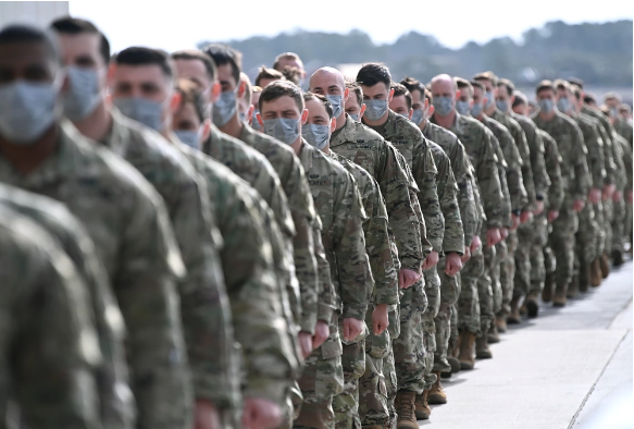 Soldiers lined up to graduate, wearing masks.