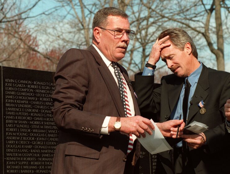 Hugh Thompson Jr. and Lawrence Colburn stand together outside. 