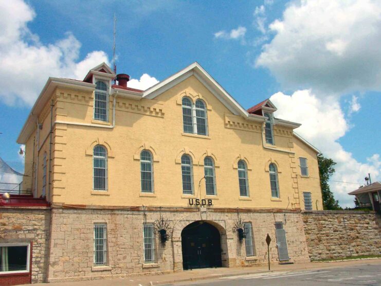 Front of Yellow building with windows and a sign reading 'USDB' above the door. 