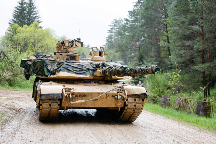 Abrams M1A2 driving along a dirt road