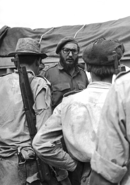 Fidel Castro standing with two men after landing at the Bay of Pigs. 