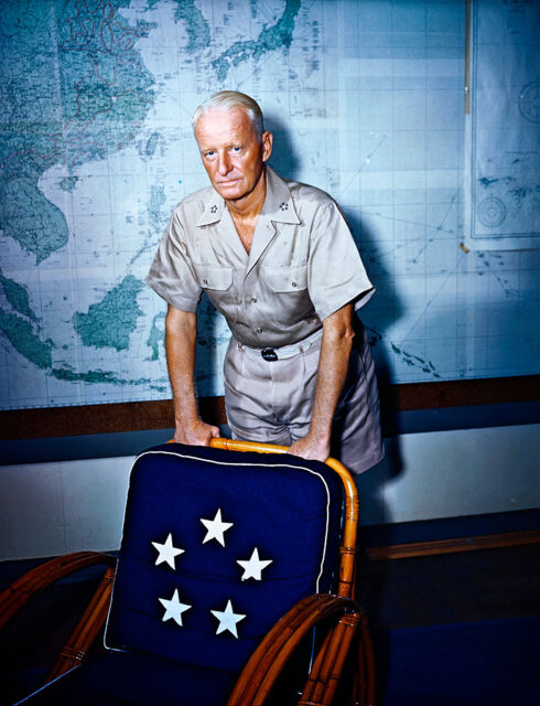 Chester W. Nimitz leaning against a chair