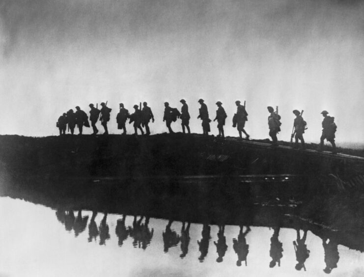 Troops walking on a duckboard track.