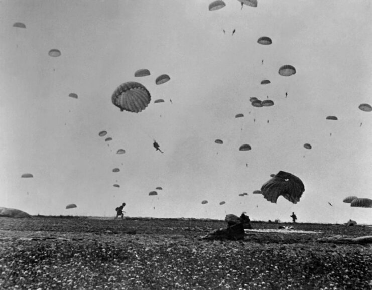 Paratroopers parachuting into a French field