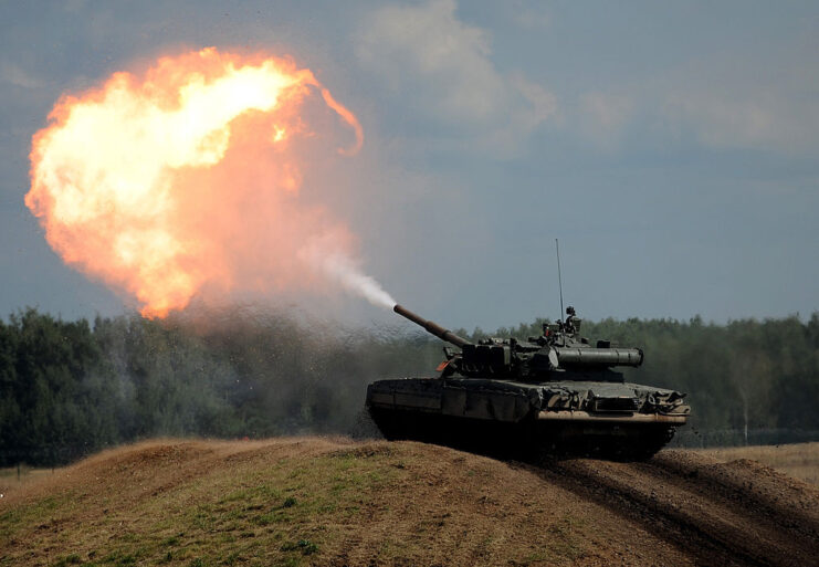 T-90 main battle tank (MBT) firing its main gun from the top of a hill