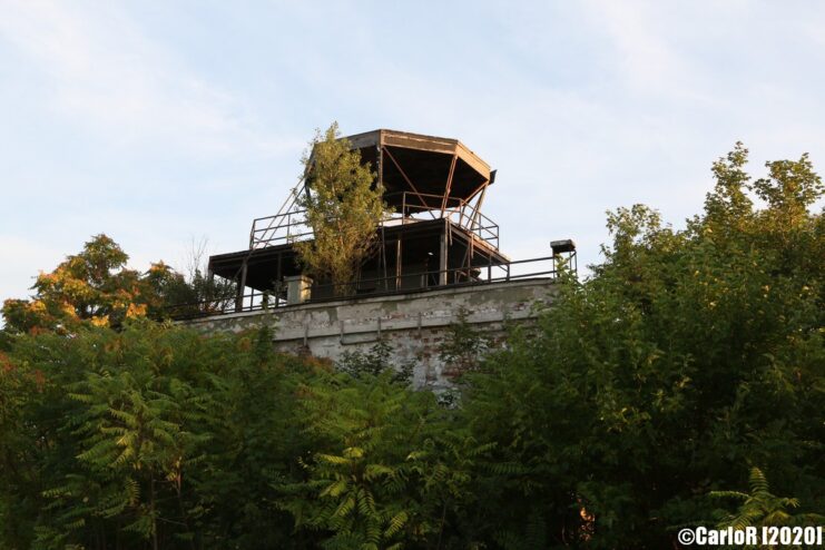 Observation tower rising above the trees and bushes at Tököl Airbase