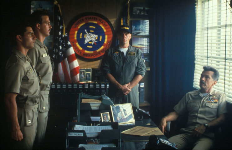 Tom Cruise and ANthony Edwards stand in front of Tom Skerritt and Michael Ironside in 'Top Gun.'