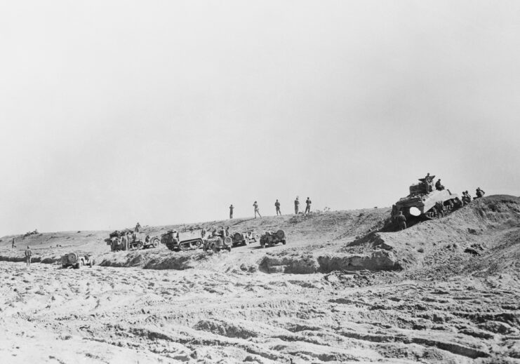 American troops standing on a sandy hill