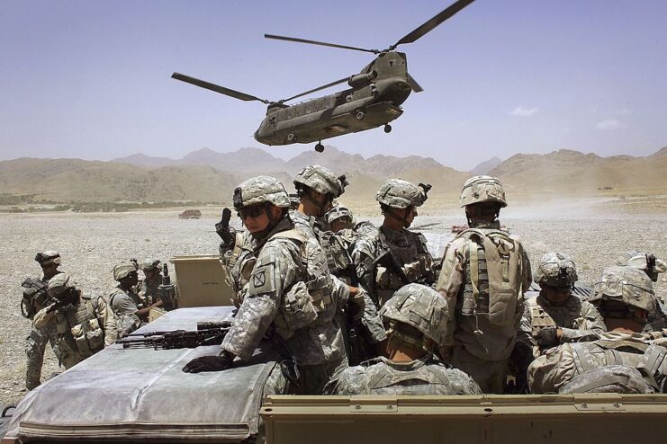 Helicopter hovering over American troops in the middle of the desert