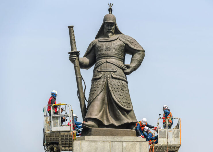 Workers cleaning a statue of Yi Sun-Sin