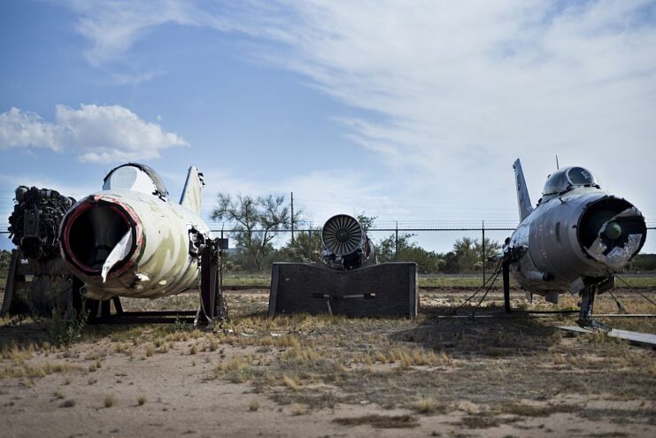 Remains of a Mikoyan-Gurevich MiG-15 and a Mikoyan MiG-29 parked by a fence