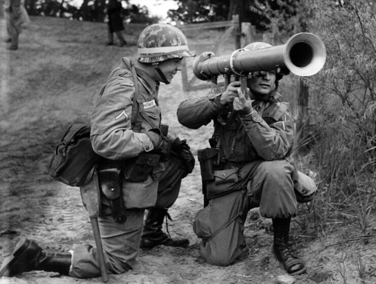 Two American soldiers holding a bazooka.