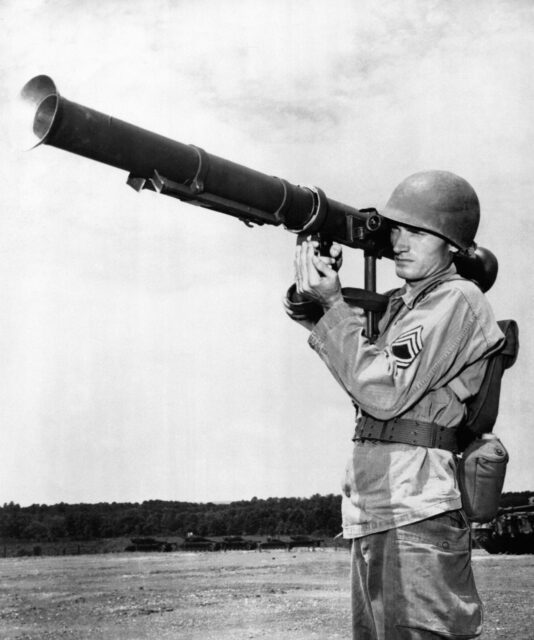 American soldier holding. a bazooka over his shoulder. 