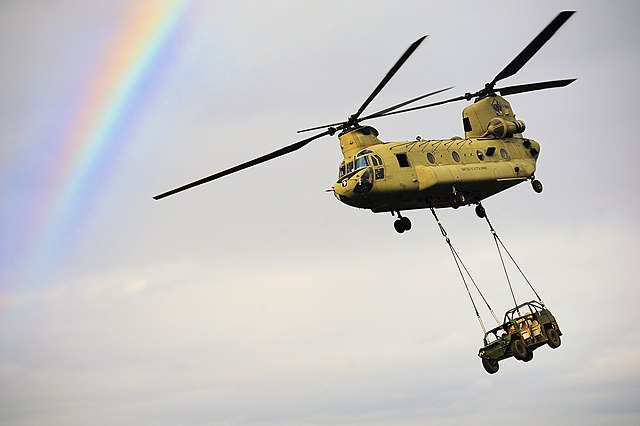 Boeing CH-47 Chinook carrying a military vehicle while in-flight