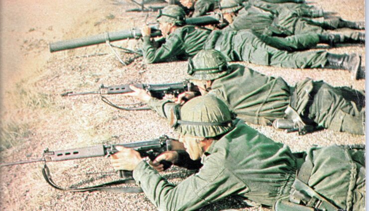 Argentine soldiers aiming FN FALs while lying on the ground