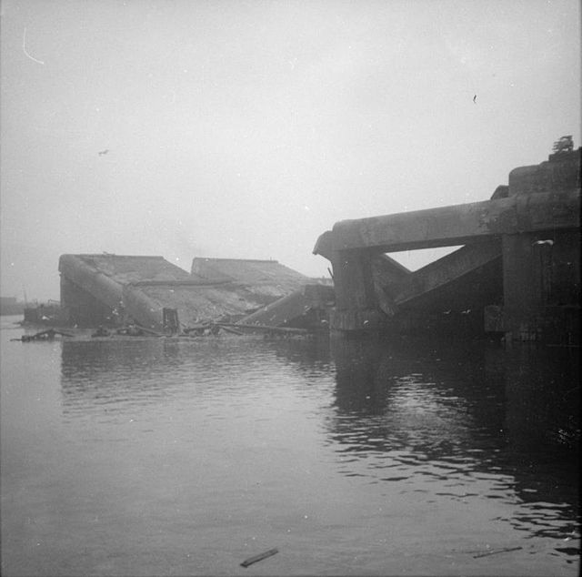 Demolished concrete U-boat pen half-submerged in water