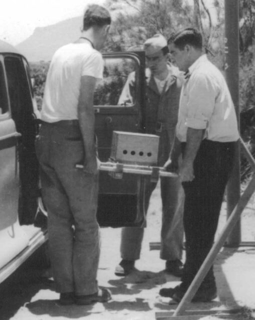 Herbert Lehr, Harry K. Daghlian, Jr. and another man loading a tamper plug into a sedan