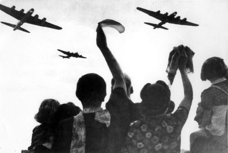 Dutch civilians waving at Allied aircraft flying overhead