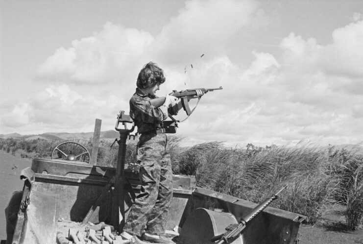 Reporter firing an M16 rifle. 