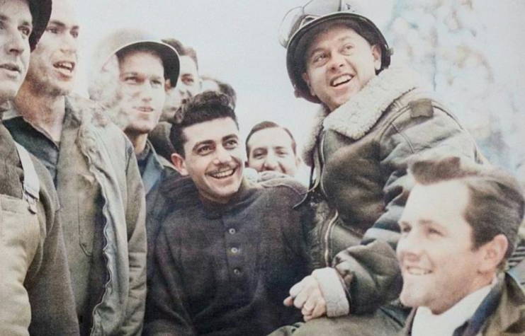 Mickey Rooney sitting with American troops