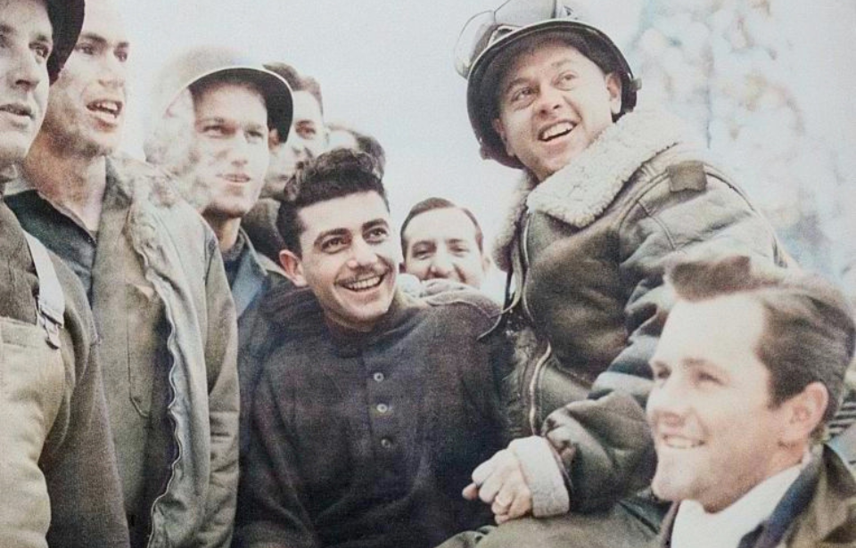 Mickey Rooney sitting with American troops