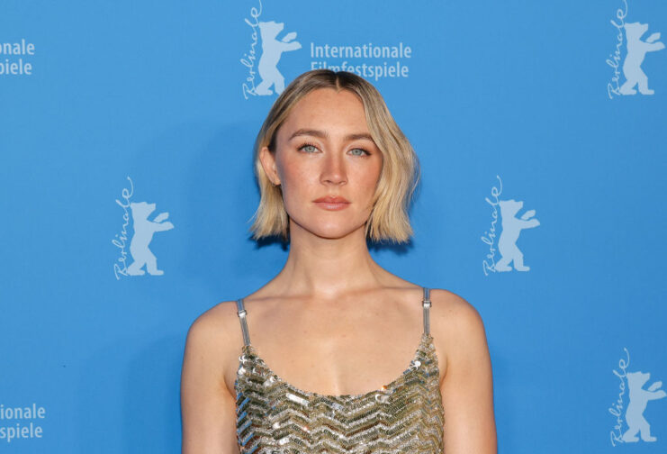 Saoirse Ronan standing on a red carpet