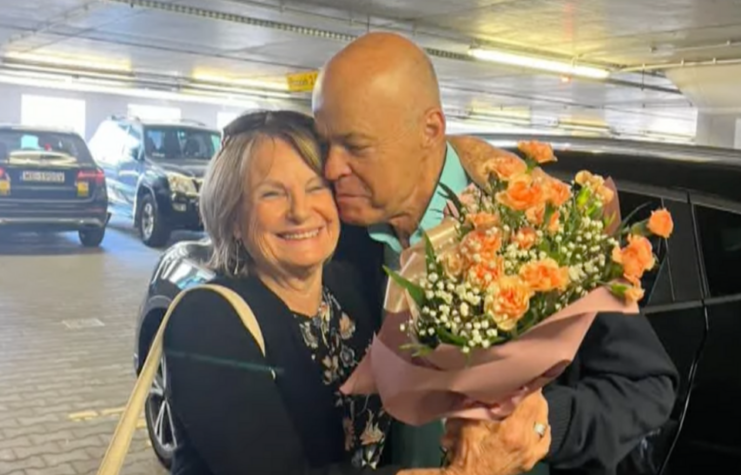 Elana Milman and Juliusz Gorzkoś hugging in a parking garage