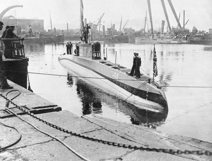 British sailors standing on a captured German U-boat. 