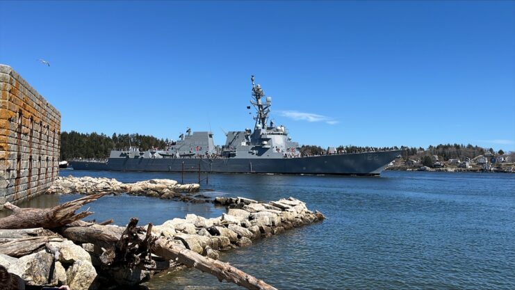 USS John Basilone (DDG-122) transiting near land