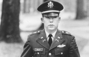 William Calley walking in his US Army uniform