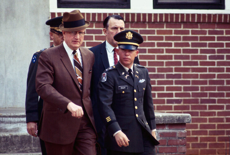 William Calley walking out of a building with his lawyers