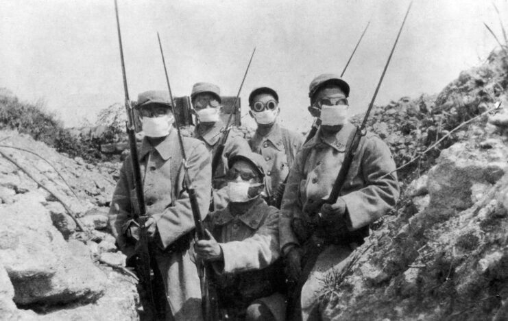 Black and white. French troops wearing makeshift gas masks. 