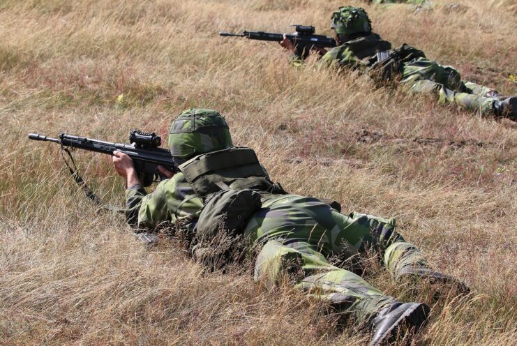 Two members of the Swedish Home Guard aiming their AK-4Bs while lying in a field