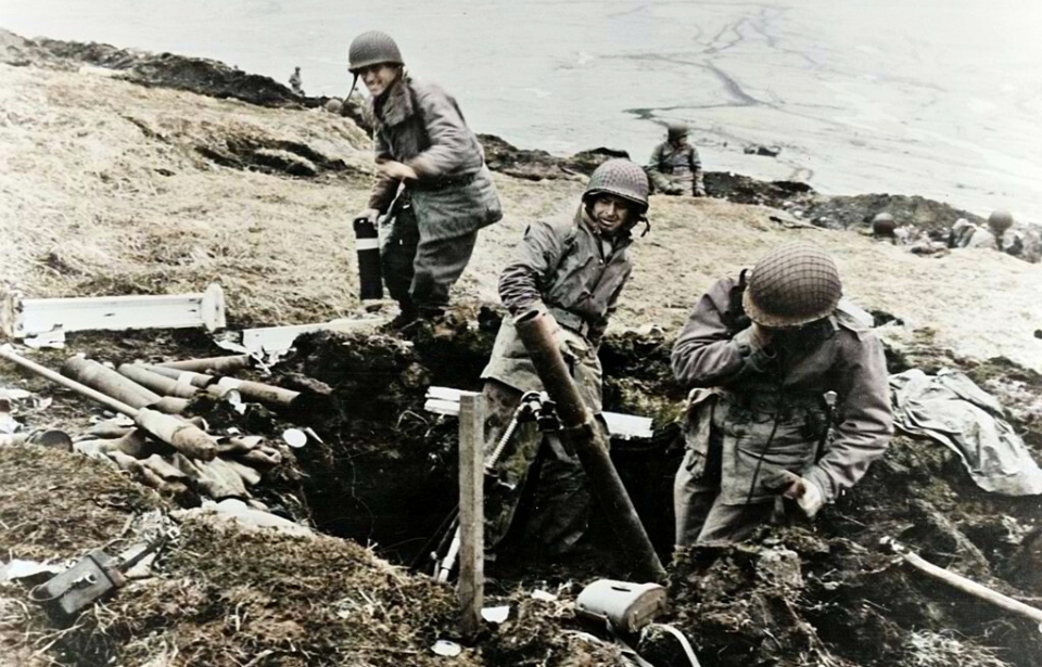 Three soldiers standing with a mortar