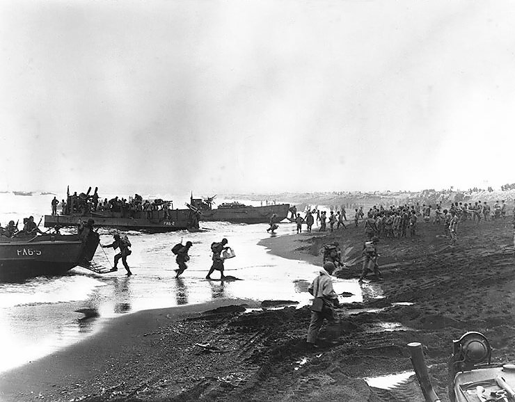 Allied troops unloading landing craft at a beach on Attu Island