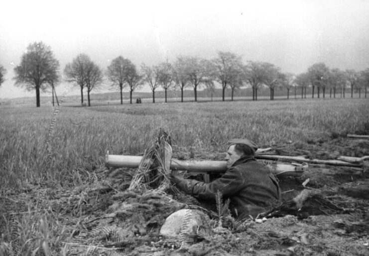 Member of the Volksstrum manning a Panzerschreck from a hole in the ground